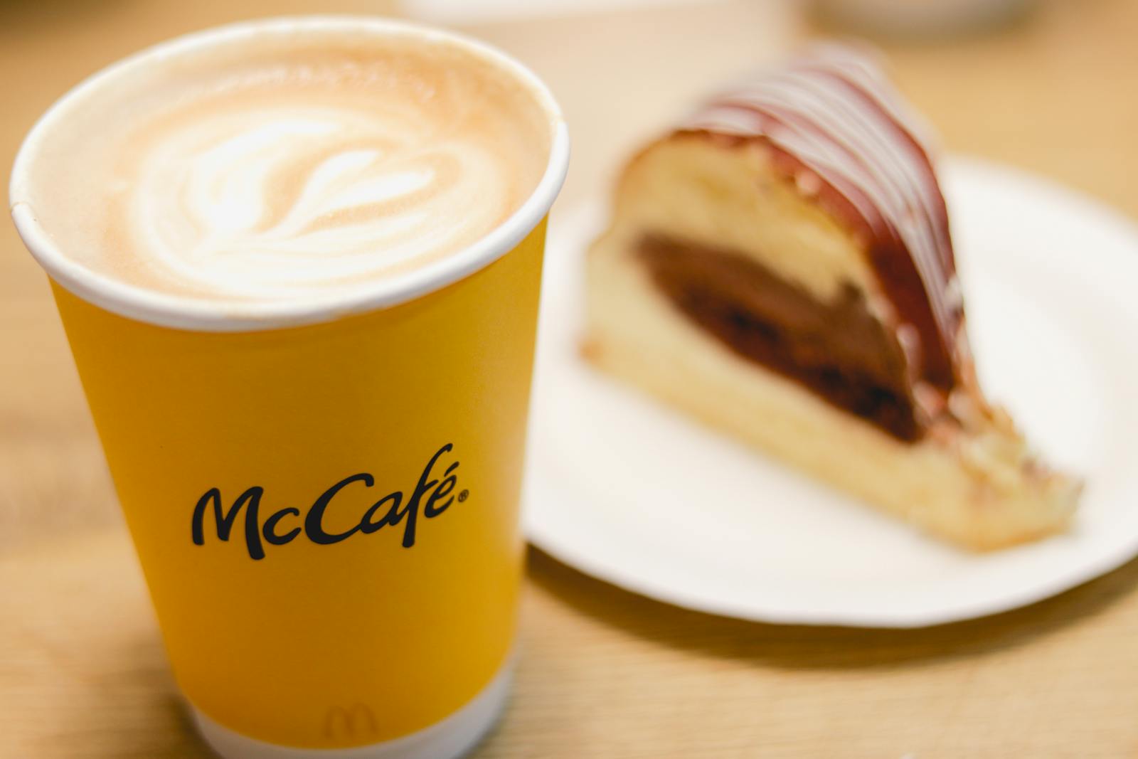 Enjoy a cappuccino and dessert at McCafé in Qatar, perfect for coffee lovers.